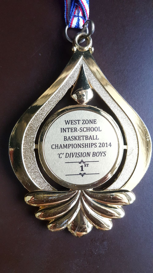 Picture of medal that states 'WEST-ZONE INTER-SCHOOL BASKETBALL CHAMPIONSHIPS 2014 C DIVISION BOYS 1st