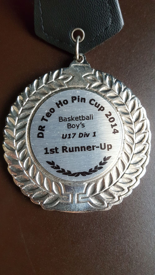 Picture of medal that states 'DR Teo Pin Cup 2014 Basketball Boy's U17 Div 1 1st Runner-Up